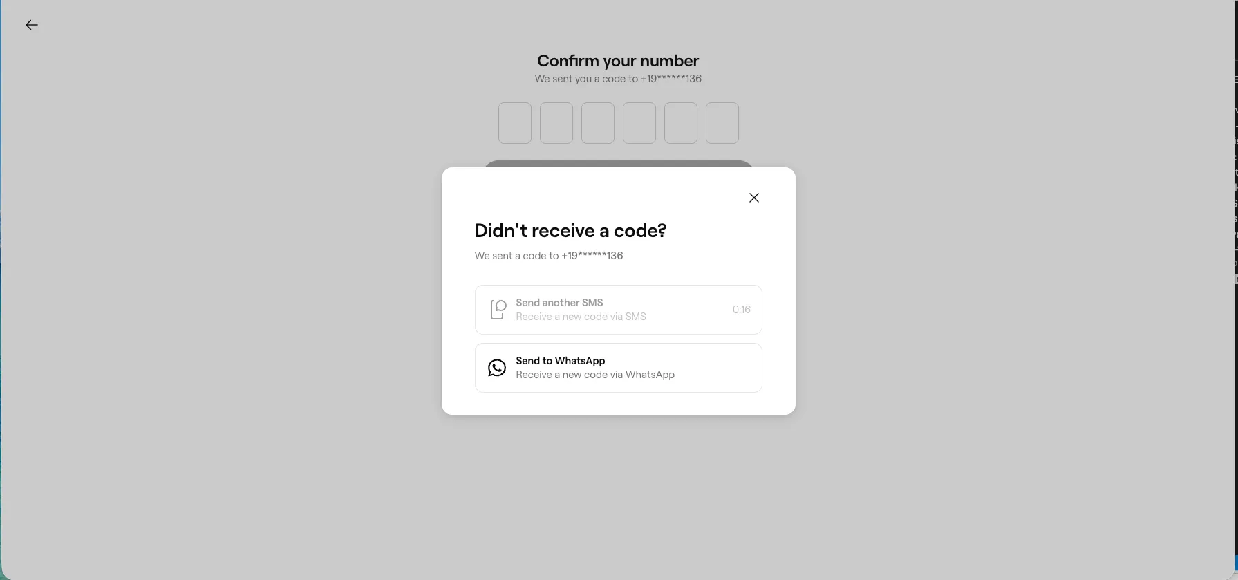 Fresha login screen asking to confirm a code sent to a masked phone number, with a dialog offering only Send another SMS or Send to WhatsApp to the same number